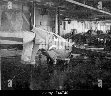 A photograph showing damage to an F4F Wildcat aboard the USS Midway during World War II, highlighting the impact of combat on naval aviation. Stock Photo