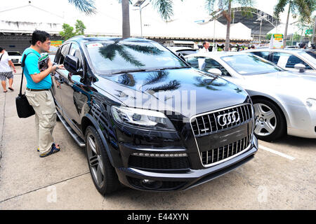 Bangkok, Thailand. 3rd July, 2014. A man looks at a smuggled car during an auction at Thai Customs Department in Bangkok, Thailand, July 3, 2014. Credit:  Rachen Sageamsak/Xinhua/Alamy Live News Stock Photo