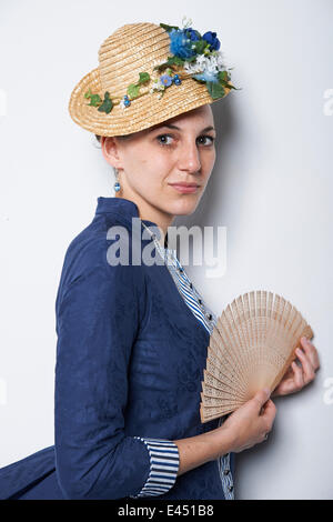 Young woman with hat and fan Stock Photo