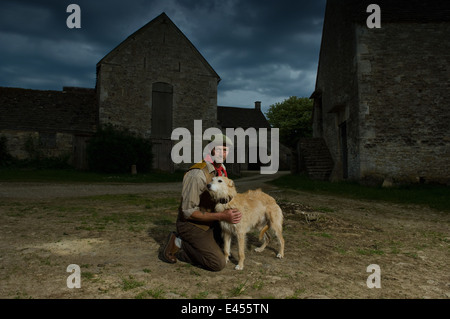 Portrait of mature traditional farmer and his lurcher dog Stock Photo