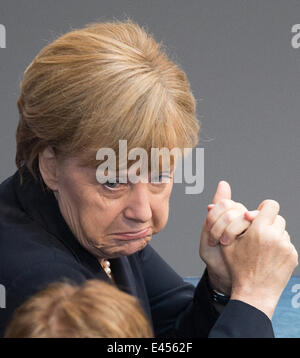 Berlin, Germany. 03rd July, 2014. German Chancellor Angela Merkel sits in the German Bundestag in Berlin, Germany, 03 July 2014. The Bundestag is debating the minimun wage. Photo: Maurizio Gambarini/dpa/Alamy Live News Stock Photo