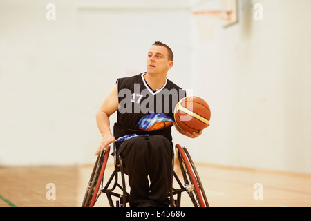 Wheelchair basketball player holding ball Stock Photo