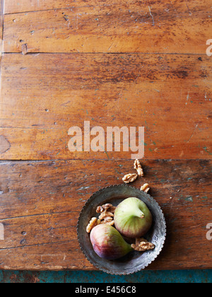 Still life of fresh figs and walnuts in a bowl Stock Photo