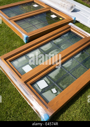 self building house, engineered oak leaded windows laid on grass after delivery on site Stock Photo