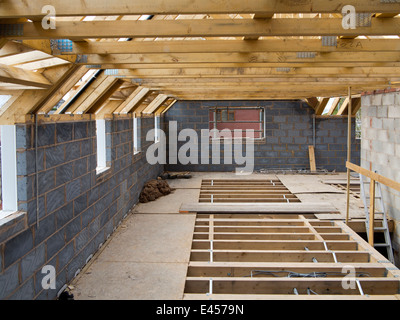 self building house, upper floor with traditional wooden joists and prefabricated roof trusses before flooring Stock Photo