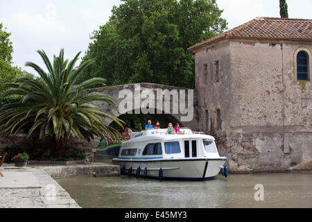 Family cruising on the Canal Du Midi, Le Somail, France. July 2009. Model released. Stock Photo