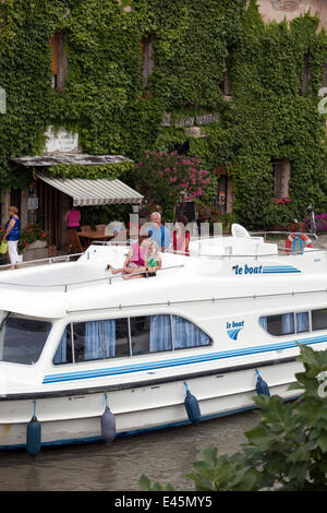 Family cruising on the Canal Du Midi, Le Somail, France. July 2009. Model released. Stock Photo