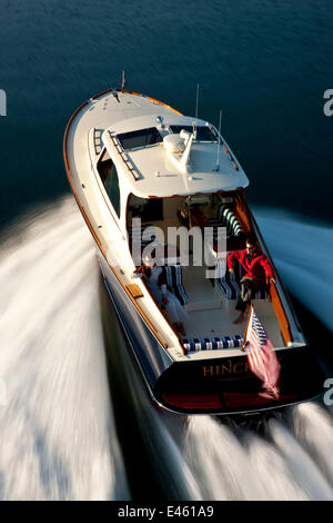 Couple on board Hinckley T38 speedboat planing off Rhode Island, USA, August 2008. All non-editorial uses must be cleared individually. Stock Photo