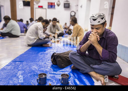 Bangkok, Thailand. 3rd July, 2014. A man prays before Iftar, the meal that breaks the day long fast at Haroon Mosque in Bangkok during the holy month of Ramadan. Ramadan is the ninth month of the Islamic calendar, and the month in which Muslims believe the Quran was revealed. The month is spent by Muslims fasting during the daylight hours from dawn to sunset. Fasting during the month of Ramadan is one of the Five Pillars of Islam. Credit:  ZUMA Press, Inc./Alamy Live News Stock Photo