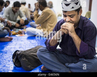 Bangkok, Thailand. 3rd July, 2014. A man prays before Iftar, the meal that breaks the day long fast at Haroon Mosque in Bangkok during the holy month of Ramadan. Ramadan is the ninth month of the Islamic calendar, and the month in which Muslims believe the Quran was revealed. The month is spent by Muslims fasting during the daylight hours from dawn to sunset. Fasting during the month of Ramadan is one of the Five Pillars of Islam. Credit:  ZUMA Press, Inc./Alamy Live News Stock Photo