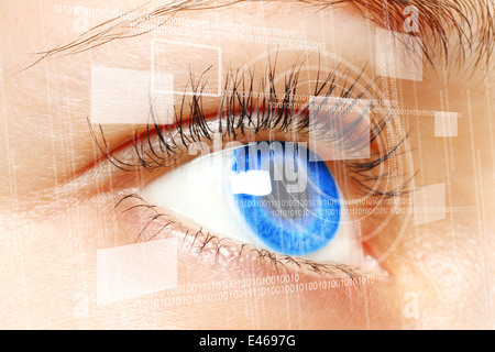 Woman blue eye looking on digital virtual screen close-up Stock Photo