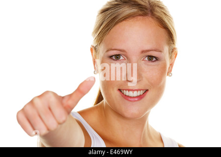 A young, successful woman holds her thumb up. Symbol for success, released, white background Stock Photo