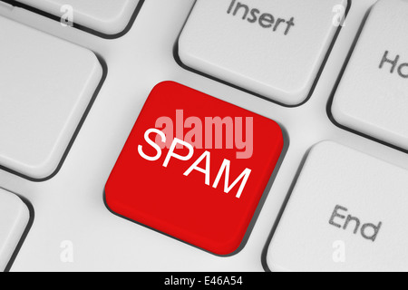 Red SPAM button on white keyboard background close-up Stock Photo