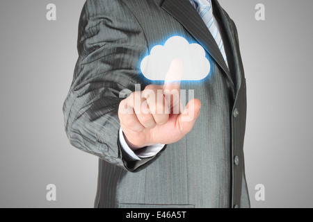 Businessman pushes virtual cloud button. Cloud computing concept Stock Photo