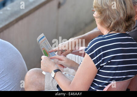 Lausanne Switzerland. 3rd July, 2014. Early arrivers check venue plan at Diamond league Lausanne.  Credit:  Ted Byrne/Alamy Live News Stock Photo