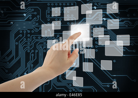Woman hand using touch screen interface on circuit board background Stock Photo