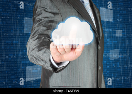Businessman pushes cloud on dark digital background, cloud computing concept Stock Photo