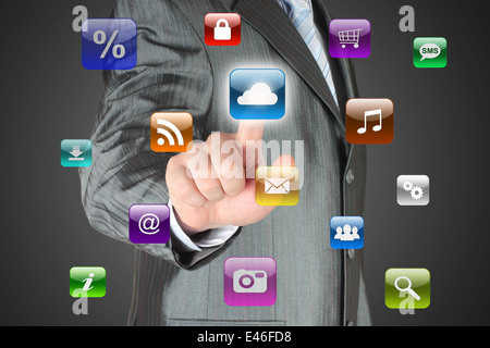 Man pushes virtual icon on dark background Stock Photo