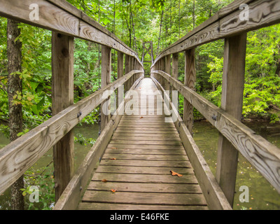 A wooden footbridge on the Appalachian Trail provides safe crossing for hikers over a river Stock Photo