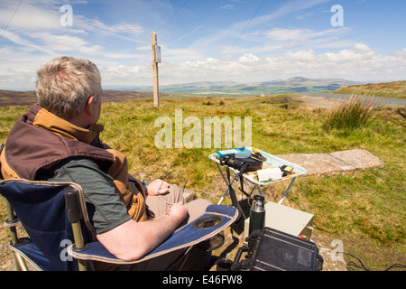 A radio ham at Bowland Knotts on the Bowland fells, UK, who had just been in touch with a fellow enthusiast in Japan. Stock Photo