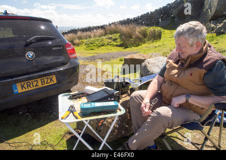 A radio ham at Bowland Knotts on the Bowland fells, UK, who had just been in touch with a fellow enthusiast in Japan. Stock Photo