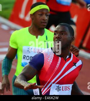 Lausanne, Switzerland. 3rd July, 2014. Justin Gatlin (front) of the United States crosses the finishing line during the men's 100m race during the IAAF Diamond League Meetings in Lausanne, Switzerland, July 3, 2014. Justin Gatlin claimed the title of the event in 9.80 seconds. Credit:  Gong Bing/Xinhua/Alamy Live News Stock Photo