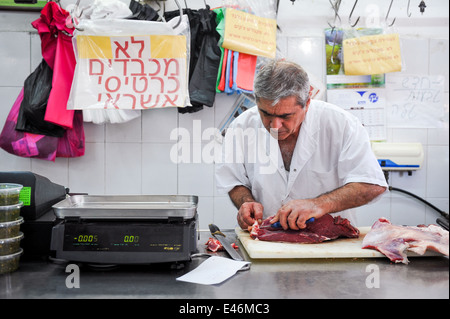 Amos the butcher, at work in the butcher shop, Jaffa, Israel Stock Photo