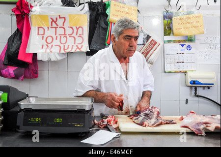 Amos the butcher, at work in the butcher shop, Jaffa, Israel Stock Photo