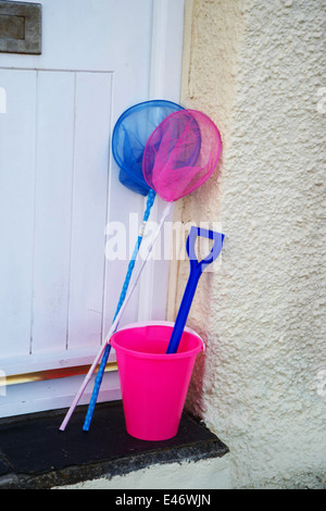 Cornwall. Roseland Peninsular. St Mawes . Pink bucket blue spade and fishing nets on doorstep. Stock Photo