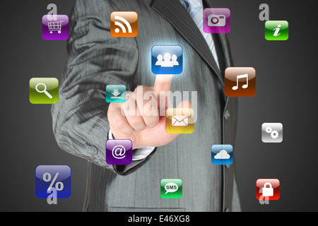 Man pushes social media button on dark background Stock Photo