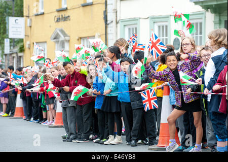 Brecon, Powys, Wales, UK. 4th July 2014. Children from Brecon Primary school wait for HRH. Prince Charles visits the Welsh market town of Brecon on the last day of the royal ‘Summer visit to Wales: Celebrating Wales, Past, Present and Future.’ After a walk through the town centre, HRH viewed the magnificent decorative and ornate Victorian interior of the recently restored Grade II listed Plough Chapel. Credit:  Graham M. Lawrence/Alamy Live News. Stock Photo