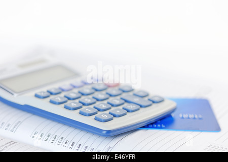 Credit card and calculator on an open diary. Shallow dof Stock Photo