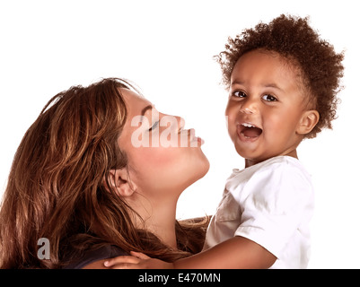 Closeup portrait of African family having fun in the studio, cheerful mother try to kiss her cute little son, happy childhood Stock Photo