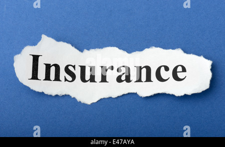 Paper cutout with text of insurance on a blue background Stock Photo