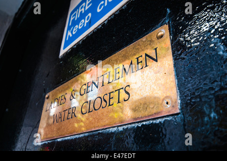 Brass sign for Ladies and Gentlemen Water Closets Stock Photo