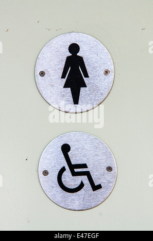 Signs for a ladies and disabled toilet on a door Stock Photo