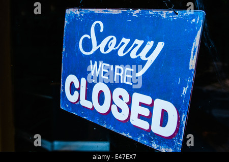 Sign on a shop saying 'Sorry. We're closed' Stock Photo