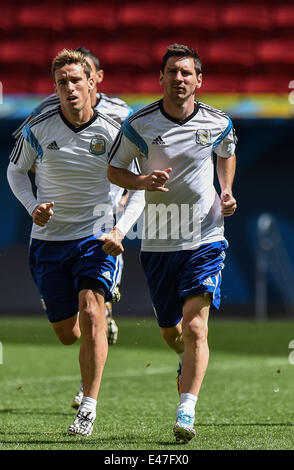 Brasilia. 4th July, 2014. Argentina's Lionel Messi (R) warms up during a training session in Brasilia, Brazil, on July 4, 2014, one day ahead of a quarter-finals match between Argentina and Belgium of 2014 FIFA World Cup. Credit:  Liu Dawei/Xinhua/Alamy Live News Stock Photo