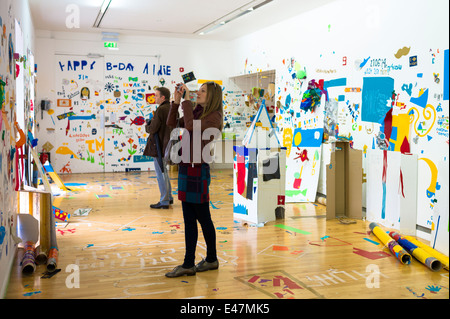 Tourists at Atelier Public 2, exhibition of artwork by members of the public in Gallery of Modern Art, GoMA, Glasgow,SCOTLAND UK Stock Photo