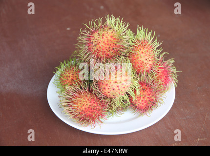 Fresh rambutan fruit in dish on the foods table. Stock Photo