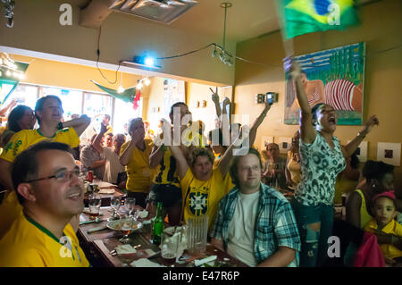 Montreal, Canada. 04th July, 2014. On Friday July 4th 2014, hundreds of Soccer fans filled Montreal cafés and streets to watch the final quarter game between Colombia and Brazil. Upon Brazil's win citizens from Brazilian origin partied on the sidewalks. Credit:  Megapress/Alamy Live News Stock Photo