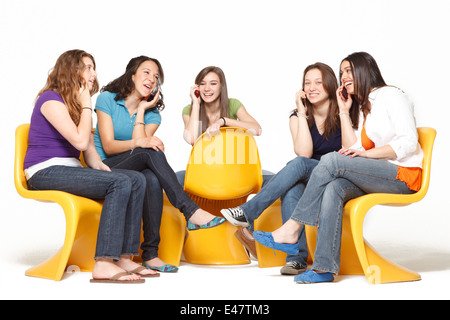 a group of five girls having fun and hanging out while talking on the cellphone Stock Photo