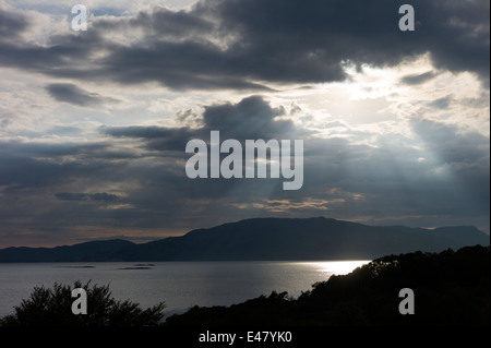 Sunrays breaking through grey clouds onto Loch Linnhe in early evening near Strontian, Argyll, in the Highlands of SCOTLAND Stock Photo