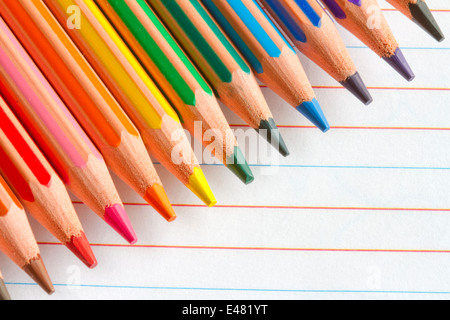 Colorful pencils crayons on white paper abstract background Stock Photo