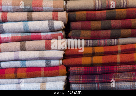 Checks, plaid and highland tartan lambswool throws and scarves for sale at Lochcarron Weavers in the Highlands of SCOTLAND Stock Photo