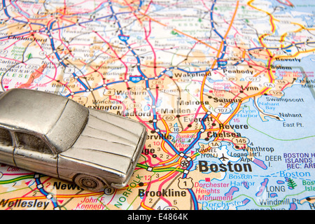 Model sedan on a road map of Boston MA