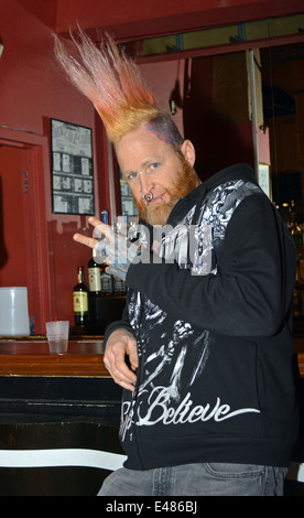 Portrait of a young man with a red mohawk hairdo  at the New York Tattoo Festival in Uniondale, Long Island, New York Stock Photo
