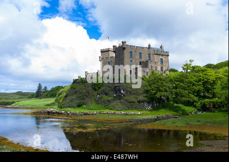 Highland fortress Dunvegan Castle, Highlands ancestral home of MacLeod clan, Dunvegan Loch sea loch on the Isle of Skye SCOTLAND Stock Photo