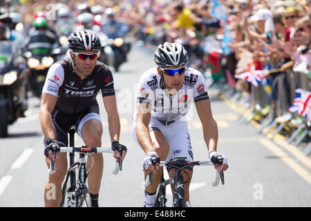 Skipton, North Yorkshire, UK. 5th July 2014 – The North Yorkshire market town of Skipton is bathed in sunshine as the 2014 Tour de France Grand Depart passes through. The town, reportedly, attracted crowds of over 20,000 people to witness the event. The French leader Benedict Jarrier is closely followed by the German rider, Jens Voigt. Credit:  Thomas Holmes/Alamy Live News Stock Photo