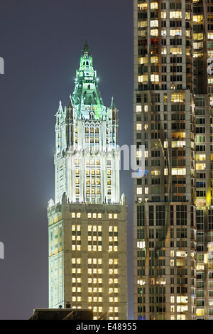 The old Woolworth Building next to other skyscrapers in New York at night Stock Photo